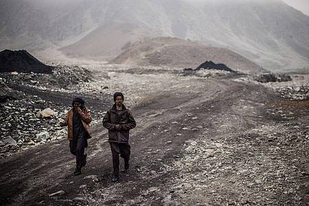 Zwei junge Bergleute verlassen am Ende ihres Arbeitstages die Kohleminen in Chinarak.
