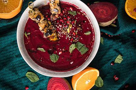 Mehr als ein Hingucker: Die Rote-Bete-Granatapfel-Suppe kann mit Hähnchen-Sesam-Spießen getoppt werden.